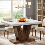 Farmhouse wooden dining table with pedestal base styled in a warm dining room