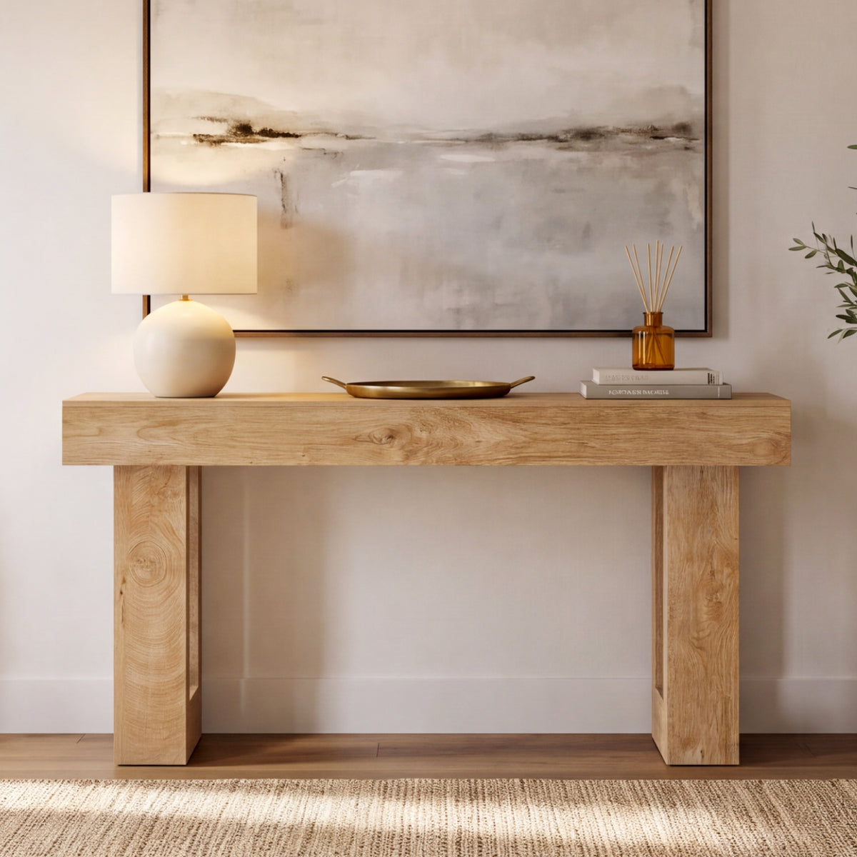 63" Wood Sofa Table with natural finish placed against a wall with modern decor, lamp and artwork in a bright entryway
#Color_Natural